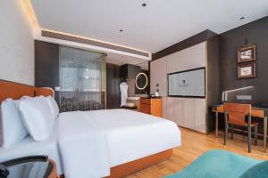 Postel nebo postele na pokoji v ubytování Licheng Bieyuan Meibao Hotel + 33 fotografií