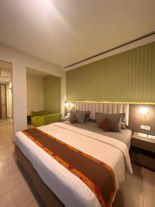 a bedroom with a large bed in a room at Xtra Hotel Bengkulu in Bengkulu