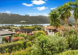 a house with a view of a lake at Cozy Water-View 2-Bdrm Suite in North Shore in Auckland