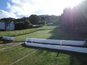 a white fence in the middle of a field at Casa do Simão in Nordeste