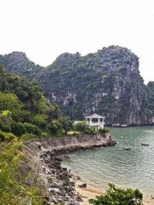 a house on a rocky island in the water at Kangaroo homestay in Cat Ba