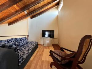 a living room with a couch and a flat screen tv at Sunsets & Surf Beach House near Puerto Nuevo in Raulis