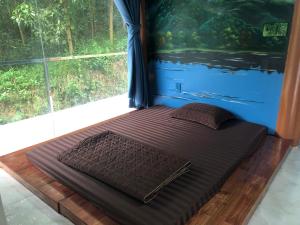 a bed in a room with a large window at Đức Tuấn Homestay in Tuyên Quang