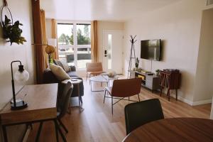 a living room with a couch and a table at The White House, A Unique ABQ Stay in Central Location near Uptown in Albuquerque
