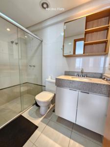 a bathroom with a toilet and a sink and a shower at Brookfield Towers - Jardim Goiás By Rei dos Flats in Goiânia +38 photos