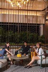 a group of people sitting around a table at Paxtonz Suites,1Utama,IKEA Damansara,SEGi,Desa Park in Petaling Jaya
