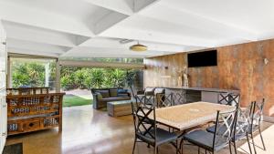 een eetkamer en woonkamer met een tafel en stoelen bij Spahaus Getaway on Morris in Mornington