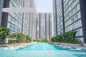 a swimming pool in a city with tall buildings at Canopy Hill Kajang 2 in Kajang