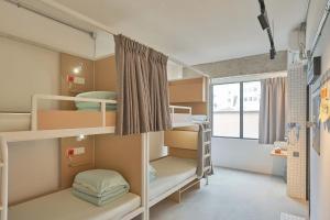 En eller flere senge i et værelse på Tiaohai Living Youth Hotel