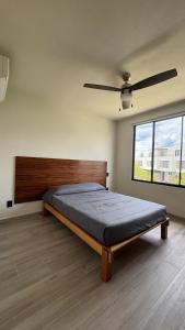 a bedroom with a bed and a large window at House Alto 58 Xochitepec Morelos in Xochitepec