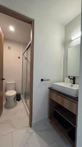a bathroom with a sink and a toilet and a mirror at House Alto 58 Xochitepec Morelos in Xochitepec +13 photos
