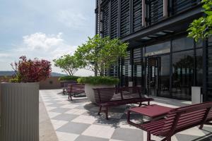 a group of benches sitting outside of a building at Paxtonz Suites,1Utama,IKEA Damansara,SEGi,Desa Park in Petaling Jaya