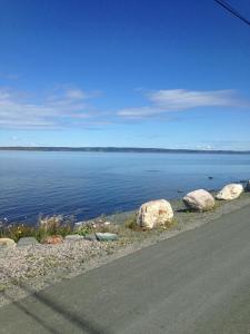a view of a large body of water with rocks at Jubilee Ocean Front in Topsail