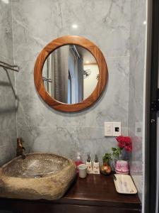 a bathroom with a sink and a mirror at Villa Full House in Vũ Lâm