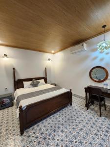 a bedroom with a bed and a table in it at Villa Full House in Vũ Lâm