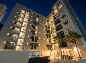 バンコクにあるUTD8 Hotel and Residenceのヤシの木が前に生えている大きな建物