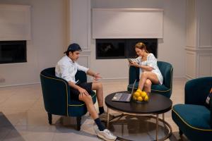 a man and a woman sitting in chairs at Paxtonz Suites,1Utama,IKEA Damansara,SEGi,Desa Park in Petaling Jaya +123 photos