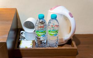 two bottles of water in a wooden box at Nueve Malioboro Hotel Yogyakarta in Yogyakarta
