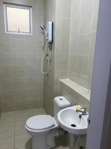 a bathroom with a toilet and a sink at UmiAbah Residensi Adelia4 in Kajang