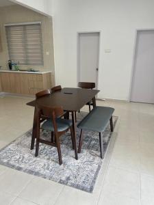 a dining room table and two chairs and a table and a table at UmiAbah Residensi Adelia4 in Kajang