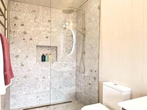 a shower with a glass door in a bathroom at Maydena Alpine Retreat in Maydena