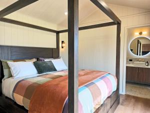 a bedroom with a large bed with a wooden frame at Maydena Alpine Retreat in Maydena
