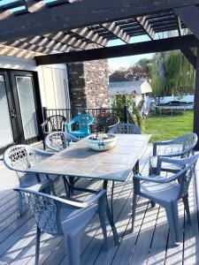 une table et des chaises en bois sur une terrasse avec une table dans l'établissement Happy Place, à South Jordan