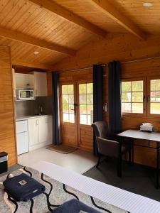 a living room with a table and a kitchen at Griffith Caravan Village in Yoogali