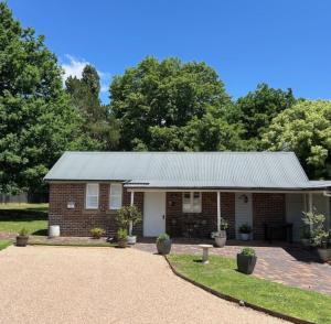 a brick house with a metal roof at The Stables in Armidale +21 photos