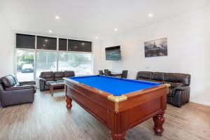 a living room with a pool table and couches at BIG4 Perth Midland Tourist Park in Middle Swan