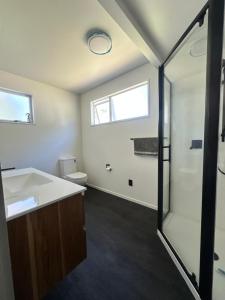 a bathroom with a sink and a shower at Kaikōura Mountain View Lodge in Kaikoura +19 photos