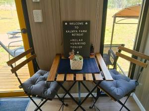 a table with a plant on it next to a door at Kalmya Farm Retreat by Tiny Away in Nanango