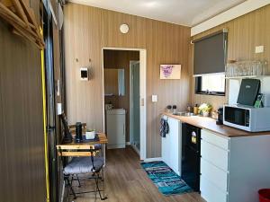 a kitchen with a sink and a microwave at Kalmya Farm Retreat by Tiny Away in Nanango