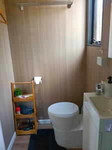 a bathroom with a white toilet and a sink at Kalmya Farm Retreat by Tiny Away in Nanango +11 photos