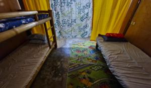 Cette chambre comprend 2 lits superposés et un rideau. dans l'établissement J Travel Trail Homestay, à Mahinog