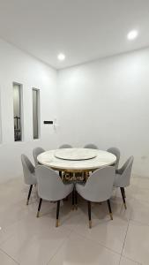 a dining room with a table and chairs at Homestay Sri Aman in Simanggang