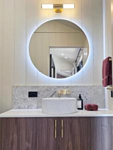 a bathroom with a sink and a mirror at Maydena Alpine Retreat in Maydena
