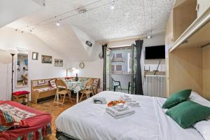 a bedroom with a bed and a dining room at Appartamento La Selva Incantata - Happy Rentals in Sauze d'Oulx
