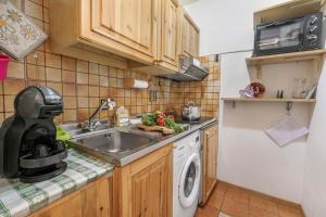 a kitchen with a sink and a washing machine at Appartamento La Selva Incantata - Happy Rentals in Sauze d'Oulx