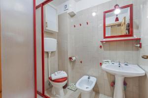 a small bathroom with a toilet and a sink at Appartamento La Selva Incantata - Happy Rentals in Sauze d'Oulx