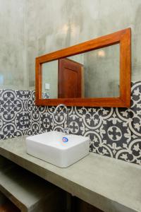 a bathroom with a white sink and a mirror at Villa302 in Galle