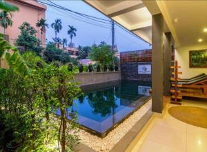 a swimming pool in the middle of a house at Siem Reap ABACUS Hotel in Siem Reap