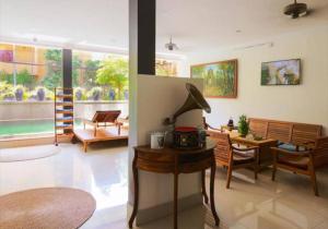 a living room with a table and chairs and a lamp at Siem Reap ABACUS Hotel in Siem Reap