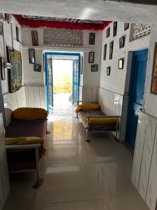 a room with a hallway with benches and a door at Mirvana hotel & Camel safari in Jaisalmer +77 photos
