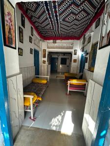 a room with beds in a room with a ceiling at Mirvana hotel & Camel safari in Jaisalmer