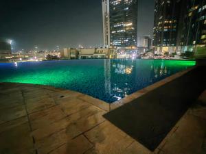 una piscina en una ciudad por la noche en Luxury home, en Abu Dabi 11 fotos más
