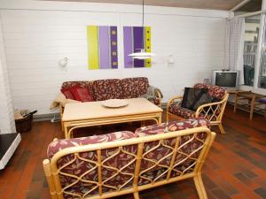 a living room with a couch and a table and chairs at 6 person holiday home in Hanstholm- Type1 in Hanstholm
