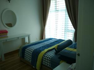 a small bedroom with a bed and a window at Sarah Suite@D'Perdana Condo in Kota Bharu