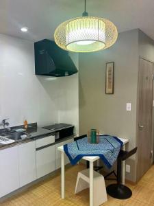a kitchen with a table with a blue cloth on it at 時の宿 in Kawagoe