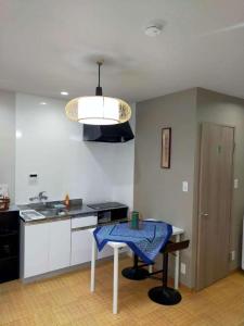 a kitchen with a table with a blue towel on it at 時の宿 in Kawagoe